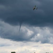 A tornado forming as a funnel-shaped storm cloud.