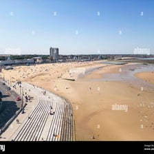 A broad expanse of sandy beach viewed from above.