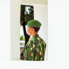 A uniformed guard standing watch.