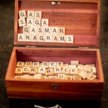 Letter tiles rearranged from WOMEN IS to form WINSOME.