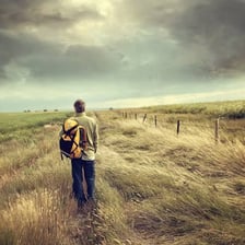 A person walking along a road in the countryside