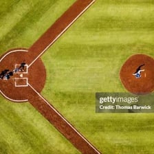 A baseball batter standing at home plate during a game.