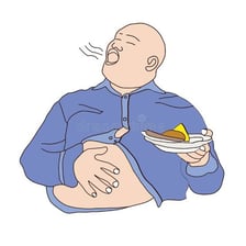 A person looking completely satisfied after eating a large meal