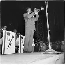 Louis Armstrong playing trumpet during a performance