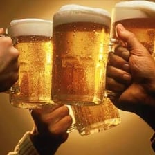 A full glass of beer associated with a cheerful celebration.