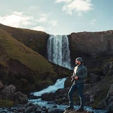 An Icelandic person shown against an Icelandic landscape