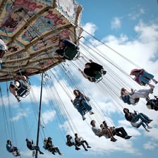People having fun on an amusement-park ride.