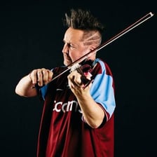 Nigel Kennedy performing with a violin on stage