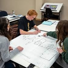 Architectural plans spread across a desk