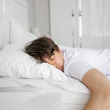 A person sleeping in bed.