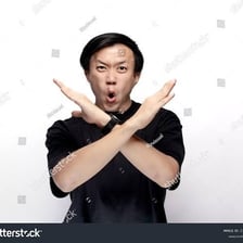A person making a clear rejecting gesture toward another person