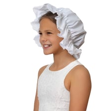 A traditional white mob cap, a gathered bonnet worn on the head.