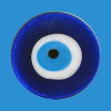 A blue evil-eye amulet displaying the traditional eye symbol