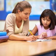 A tutor helping a student with schoolwork