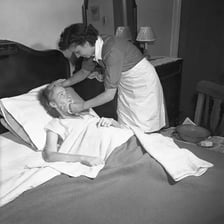 A nurse tending to a patient