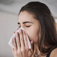 A person blowing their nose
