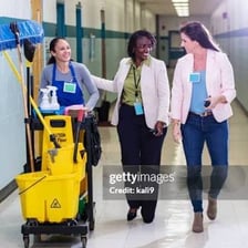 A janitor cleaning a school hallway.
