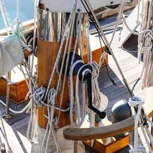 A small boat secured with a painter rope at its bow.