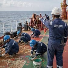 A boatswain carrying out deck duties aboard a ship.