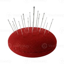 Several sharp sewing needles gathered in a pincushion.