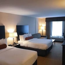 A hotel room furnished with a double bed.