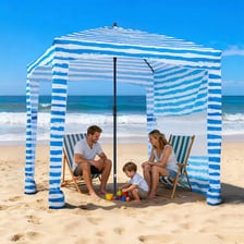 A parasol casting shade on a beach.