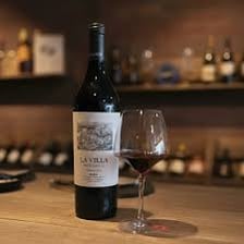 A bottle of Rioja wine beside a vineyard