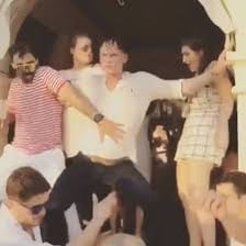 A person dancing visibly perspiring.