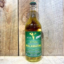 A bottle and glass of Greek retsina wine.