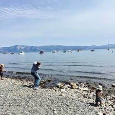 A person skipping stones across a lake