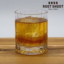 Sliced rye bread beside a glass of rye whiskey.
