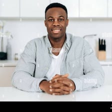 A smiling person conveying a pleasant and agreeable manner