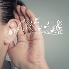 A musician concentrating while listening for musical pitch.