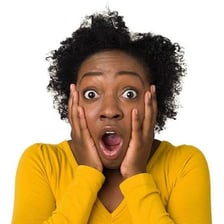 A person reacting with an astonished intake of breath