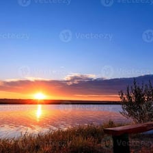 The sun rising above the horizon.