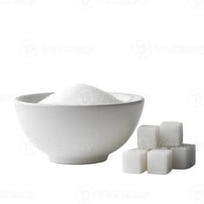 Sugar cubes beside a bowl of granulated sugar
