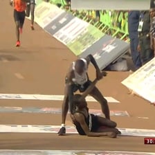 One athlete finishing ahead of a competitor in a race