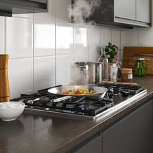 A kitchen hob with cookware resting on its burners