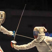 A fencing épée with a thin blade and protective guard.