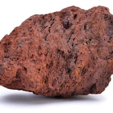 A piece of rock containing visible metal-bearing ore