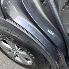 A visible dent in a car door.