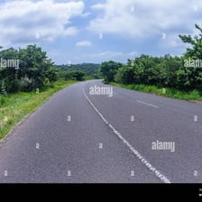A paved road serving as a route through the countryside.