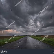 A wet street beneath dark rain clouds