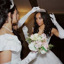 A young woman dressed formally for a society ball