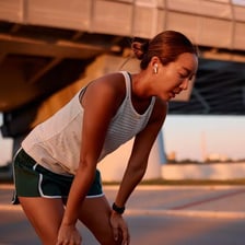 A tired runner resting after physical exertion.