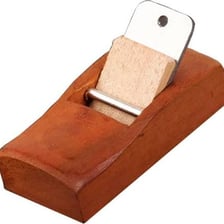 An airplane shown alongside a carpenter's hand plane