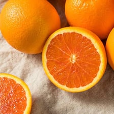 A navel orange shown whole and cut open