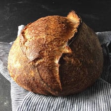 A loaf of bread cooking inside an oven