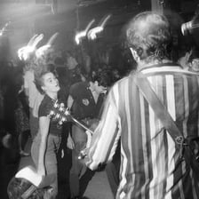 Concertgoers jumping up and down at a punk music performance