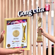 A gong-shaped ceremonial award displayed as a trophy.